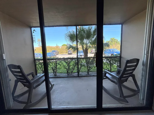 a view of a chairs and table in the balcony
