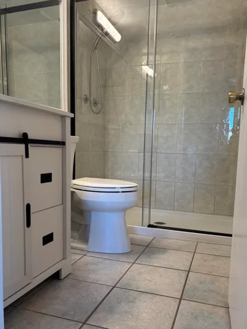a bathroom with a toilet and a shower