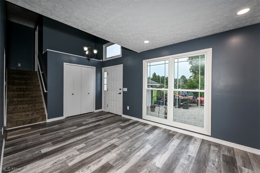 3368 Erhart Road Litchfield, OH 44253 - Photo 4 of 35 Foyer featuring a textured ceiling and hardwood floors