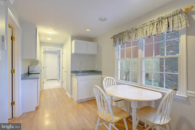 a kitchen with a table and chairs