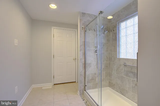 a bathroom with a shower and a bathtub