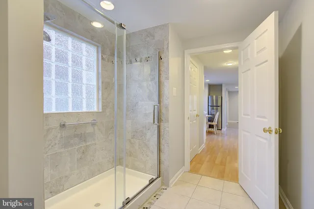 a bathroom with a shower and a glass door