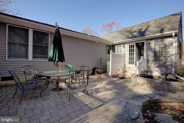 a backyard of a house with table and chairs