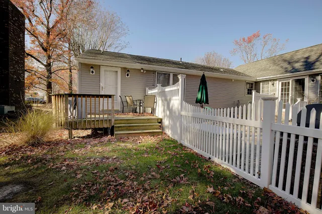a view of a house with wooden fence