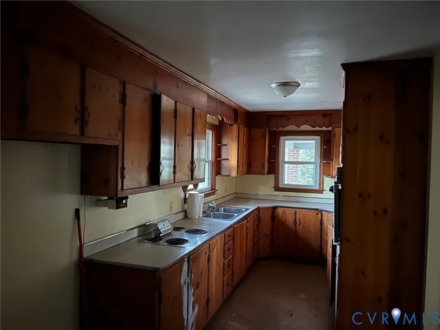 a kitchen with a sink stove and cabinets