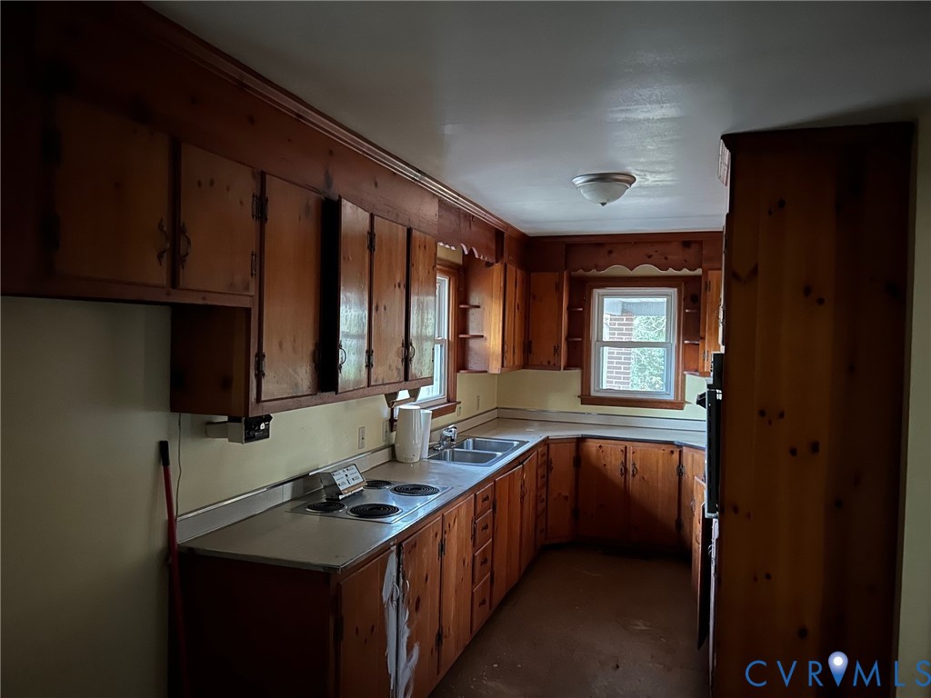 18722 Carson Road Dinwiddie, VA 23841 - Photo 4 of 10 a kitchen with a sink stove and cabinets