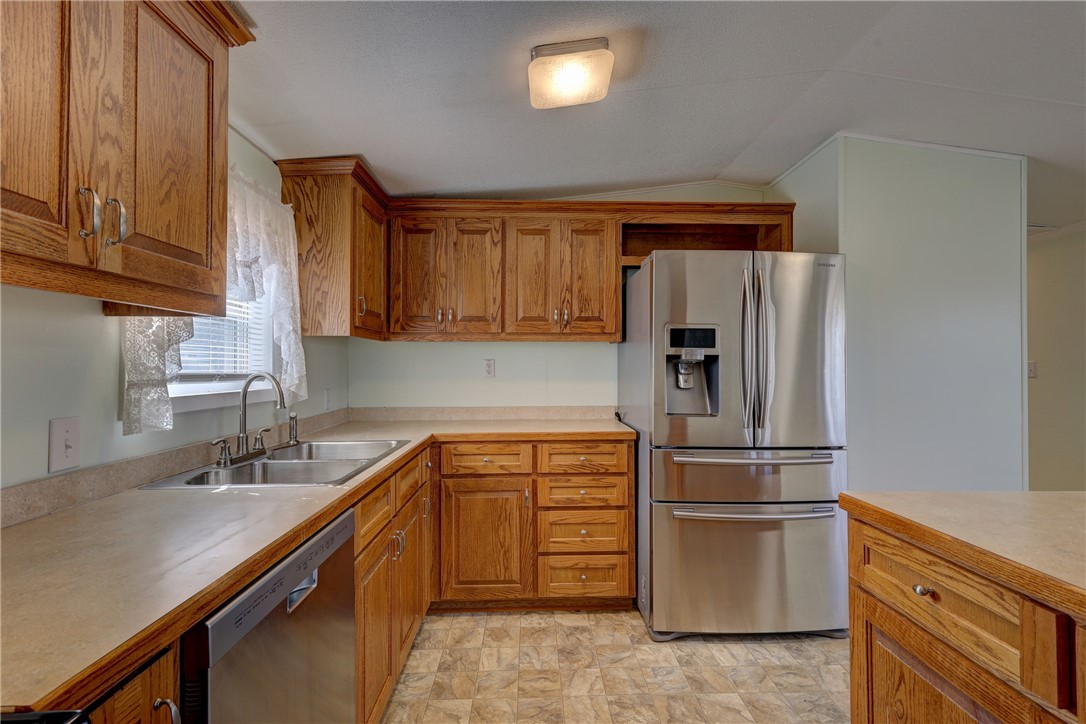 117 Denmark Street Walnut Springs, TX 76690 - Photo 11 of 40 a kitchen with appliances a sink and cabinets