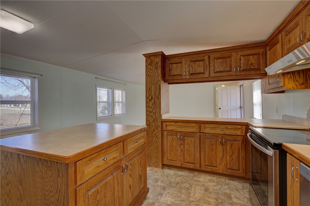 117 Denmark Street Walnut Springs, TX 76690 - Photo 13 of 40 a kitchen that has a sink and a stove in it