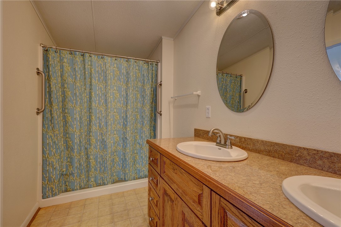 117 Denmark Street Walnut Springs, TX 76690 - Photo 16 of 40 a bathroom with a sink and a mirror