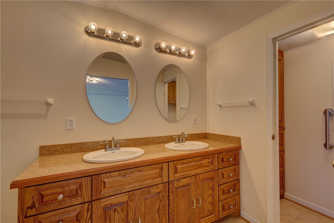117 Denmark Street Walnut Springs, TX 76690 - Photo 17 of 40 a bathroom with a double vanity sink and a mirror