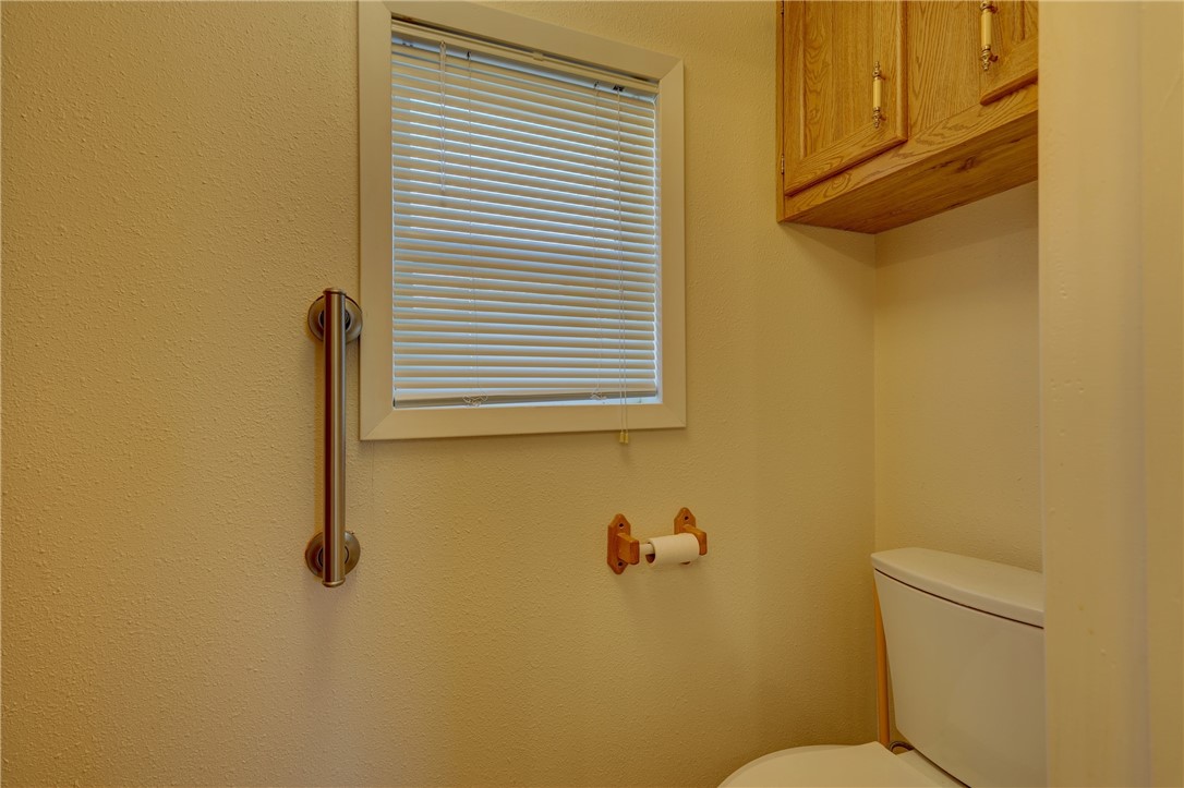 117 Denmark Street Walnut Springs, TX 76690 - Photo 18 of 40 a bathroom with a toilet and a window
