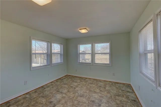 a view of a house with a yard covered in snow