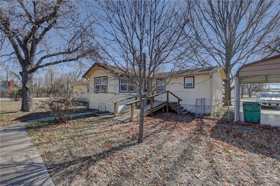 117 Denmark Street Walnut Springs, TX 76690 - Photo 27 of 40 a view of a house with a yard covered in snow