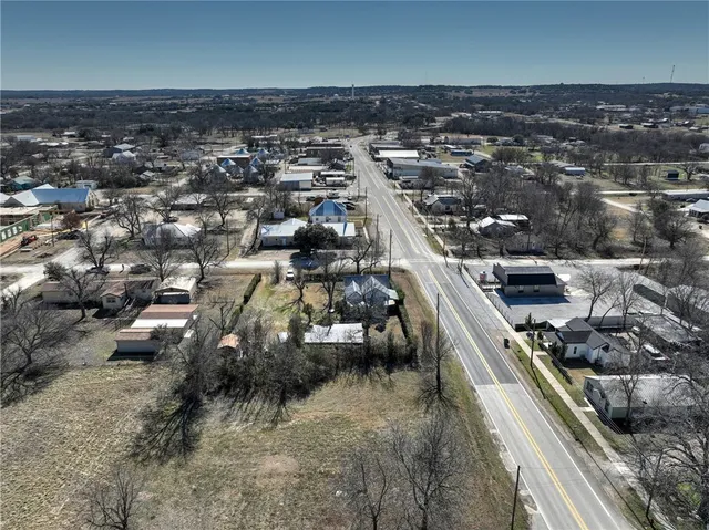 an aerial view of a house with a yard