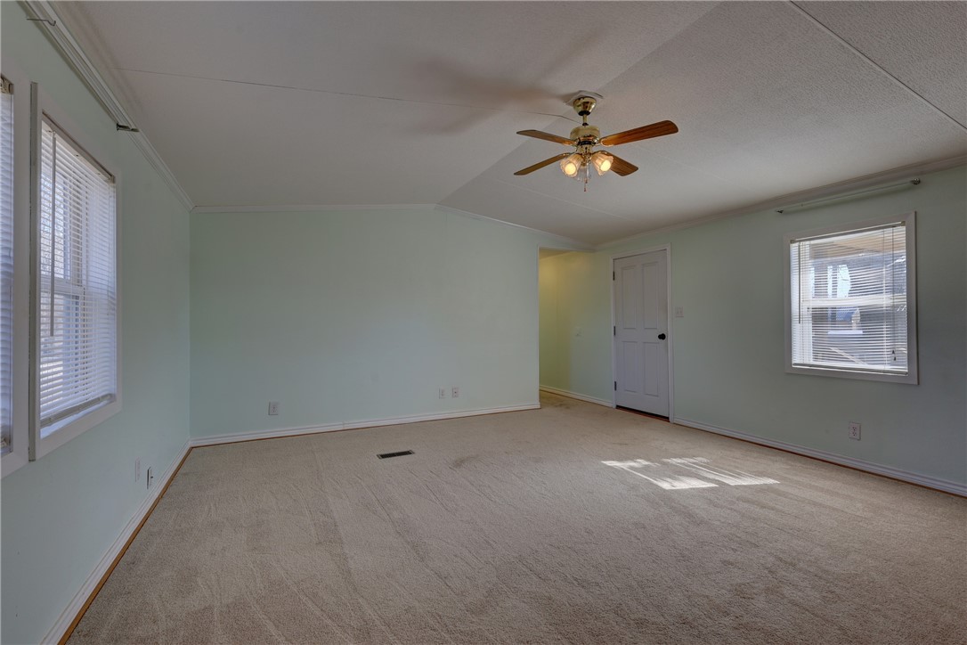 117 Denmark Street Walnut Springs, TX 76690 - Photo 6 of 40 an empty room with a window and ceiling fan