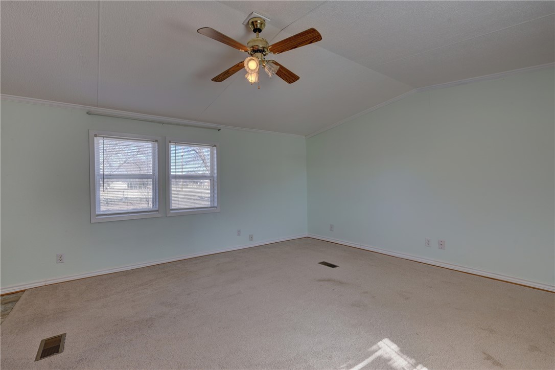 117 Denmark Street Walnut Springs, TX 76690 - Photo 7 of 40 an empty room with a window and a fan