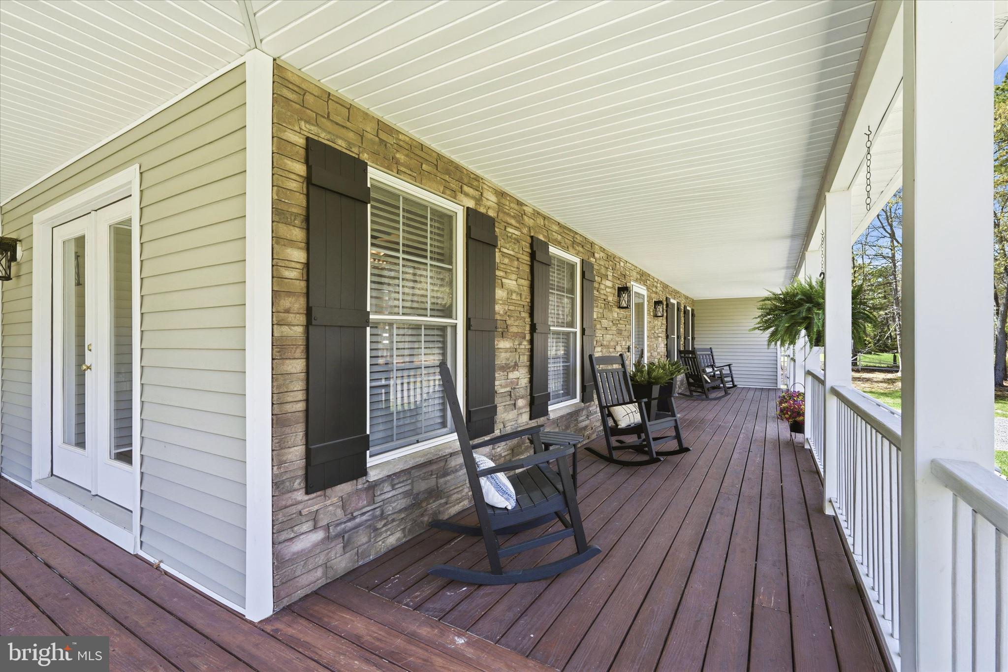 176 Warren Grove Road Barnegat, NJ 08005 - Photo 8 of 71 a view of a balcony with chairs and wooden floor