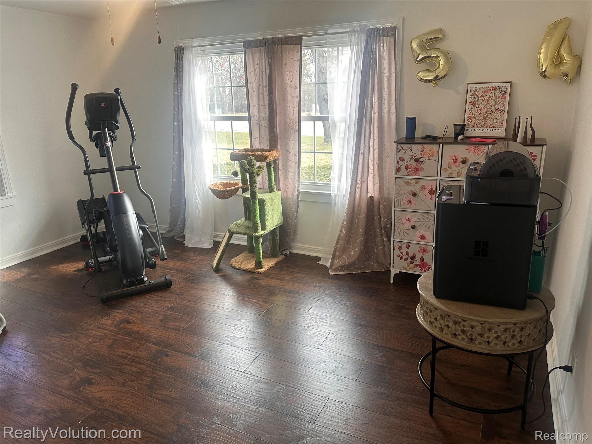 3034 West Oregon Road Lapeer, MI 48446 - Photo 13 of 29 Exercise room with dark wood-style floors and baseboards