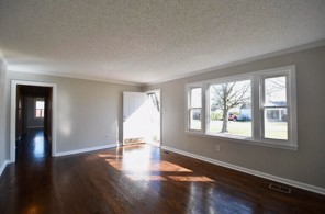 203 James Avenue Franklin, TN 37064 - Photo 18 of 26 a view of an empty room with wooden floor and a window