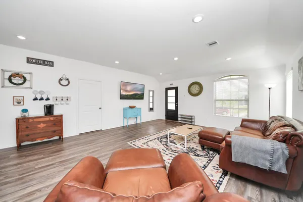 a bedroom with furniture and wooden floor