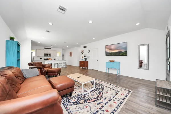 a living room with furniture or couch and a wooden floor