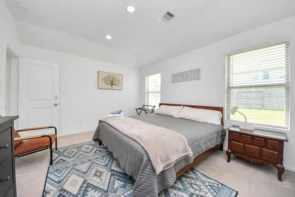 a bedroom with a bed and a couch