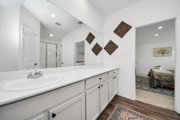a bathroom with a double vanity sink and a mirror