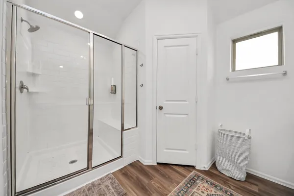 a bathroom with a shower and a sink