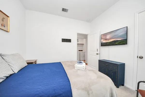 a bedroom with a bed and a flat screen tv