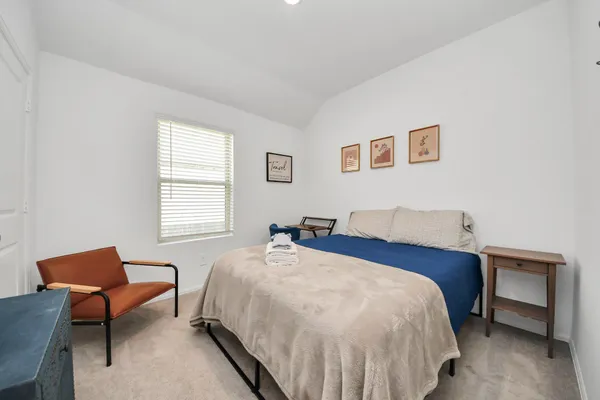 a bedroom with a bed and a window