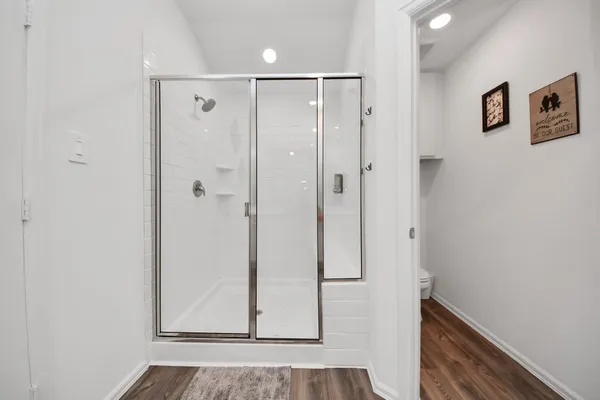 a view of a bathroom with wooden floor