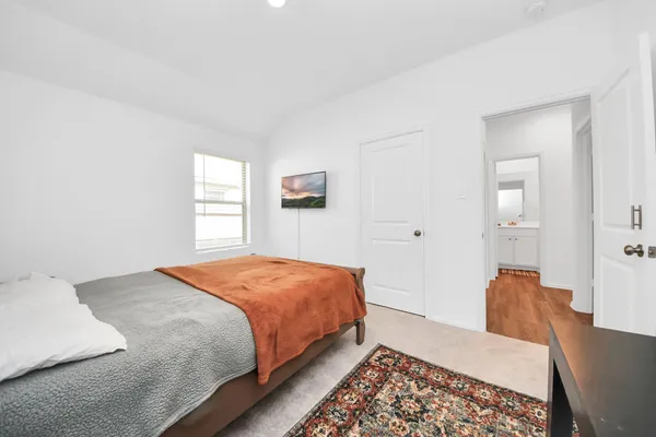 a bedroom with a bed and a window