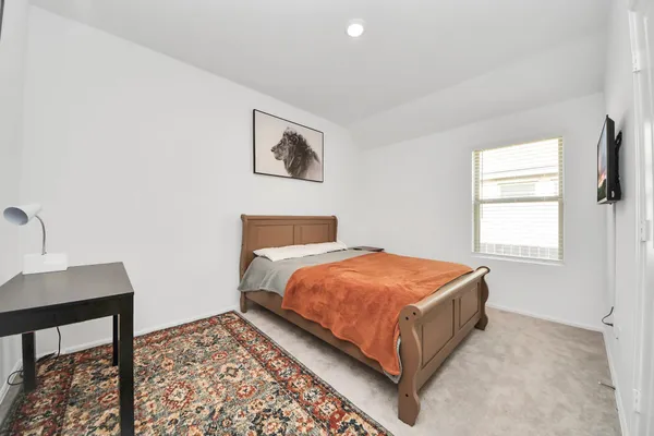 a bedroom with a bed and a table in it