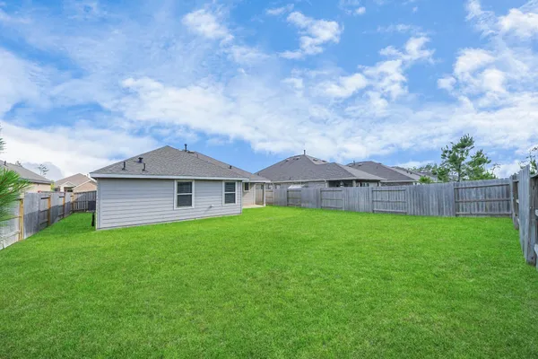a view of a house with yard and a garden