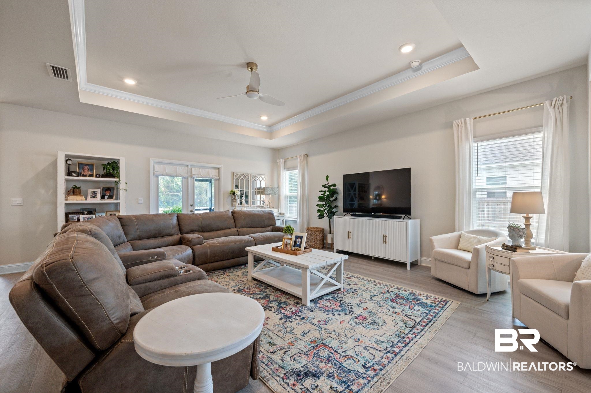 681 Calibre Street Fairhope, AL 36532 - Photo 16 of 56 Living room with french doors, a tray ceiling, ceiling fan, and light hardwood / wood-style flooring