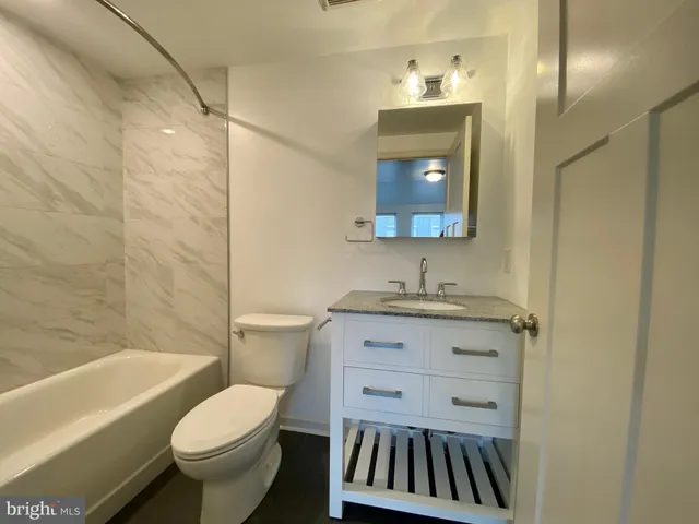 a bathroom with a shower and a bath tub