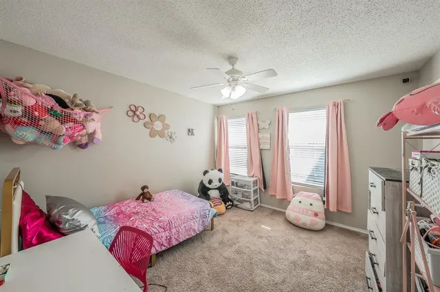 a bedroom with furniture and a chandelier