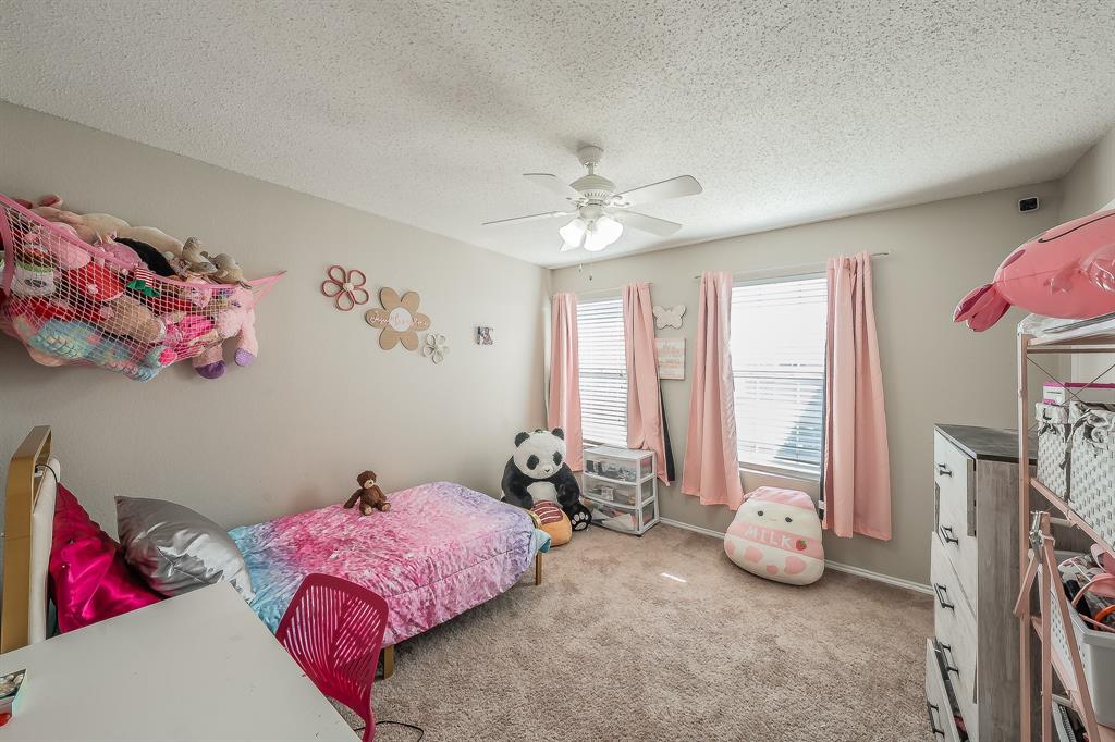 146 Independence Avenue Venus, TX 76084 - Photo 15 of 21 a bedroom with furniture and a chandelier
