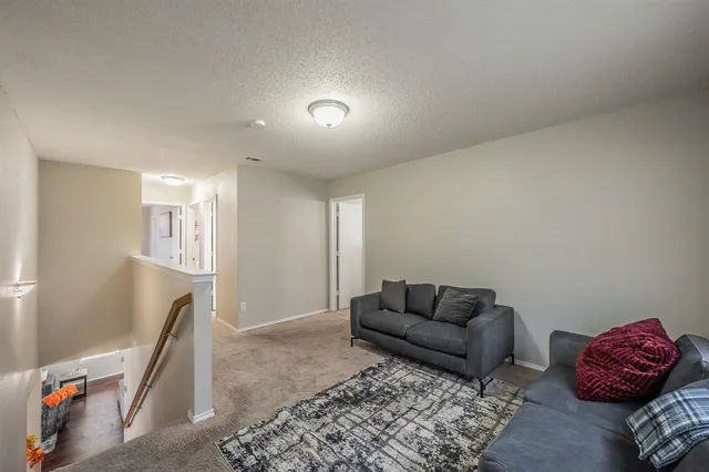 a living room with furniture and a rug