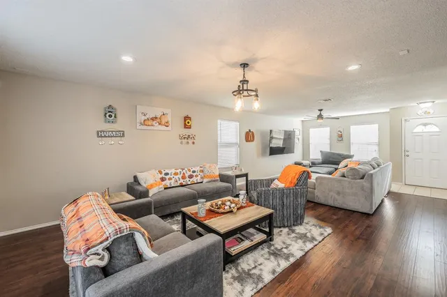 a living room with furniture and wooden floor