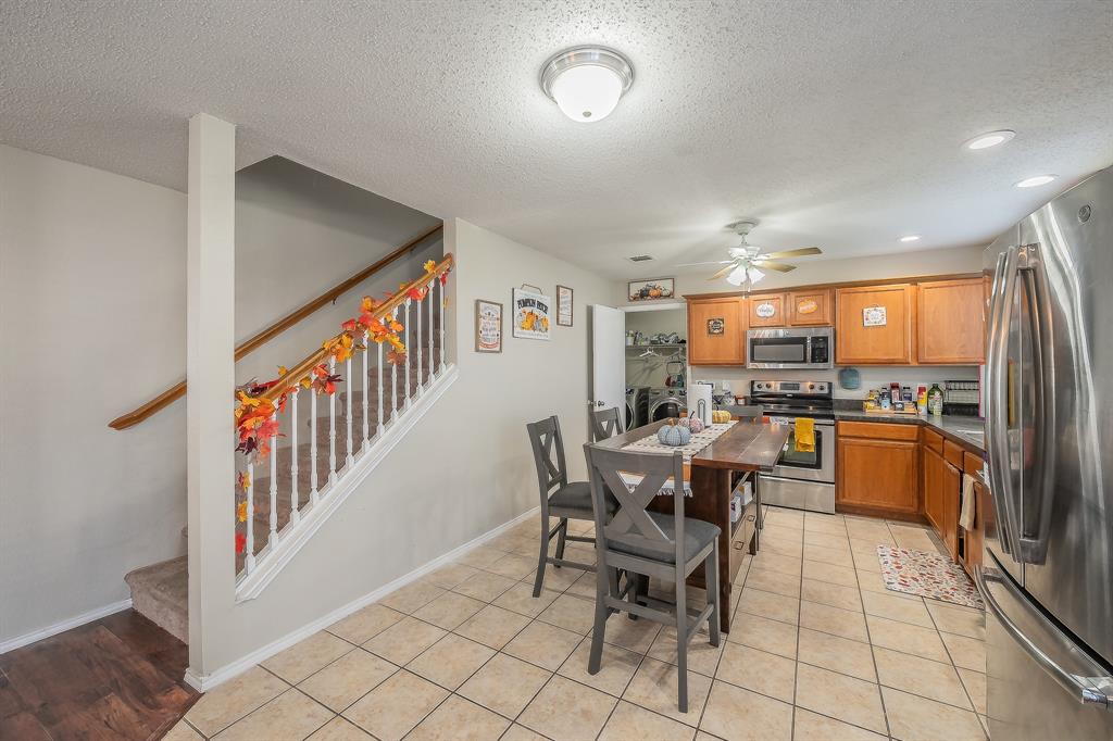 146 Independence Avenue Venus, TX 76084 - Photo 8 of 21 a dining room with furniture and a kitchen view