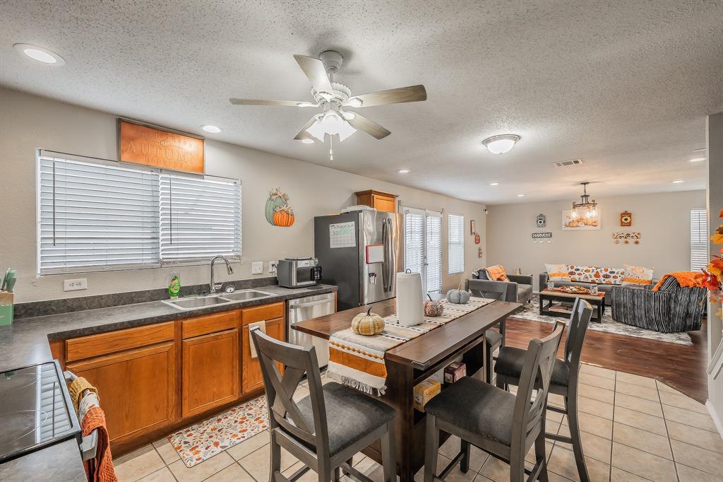 146 Independence Avenue Venus, TX 76084 - Photo 9 of 21 a dining hall with stainless steel appliances granite countertop a dining table and chairs