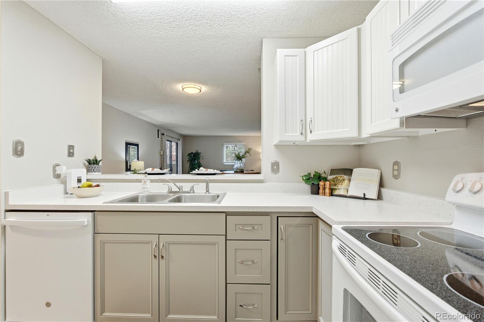 2880 South Locust Street, Unit 200S Denver, CO 80222 - Photo 11 of 43 a kitchen with white cabinets sink and white appliances