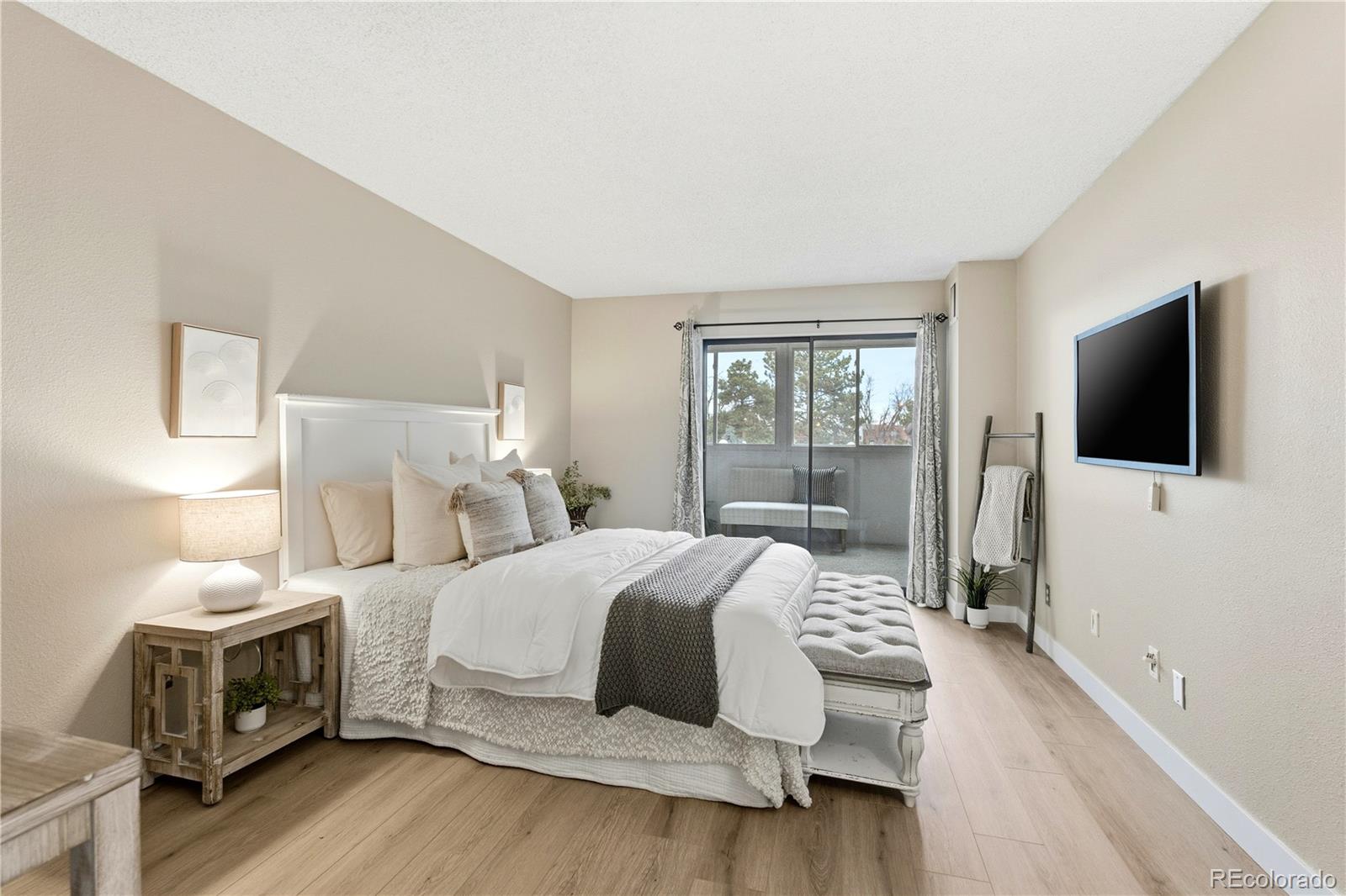 2880 South Locust Street, Unit 200S Denver, CO 80222 - Photo 13 of 43 a bedroom with a bed and a flat screen tv