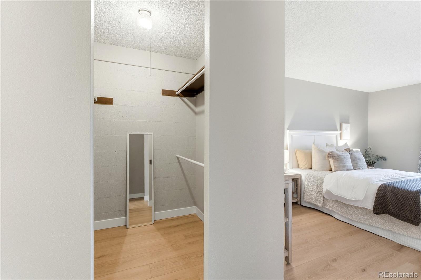 2880 South Locust Street, Unit 200S Denver, CO 80222 - Photo 17 of 43 a bedroom with a bed and a cabinets