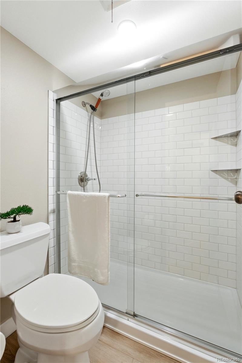 2880 South Locust Street, Unit 200S Denver, CO 80222 - Photo 20 of 43 a bathroom with a toilet and a shower