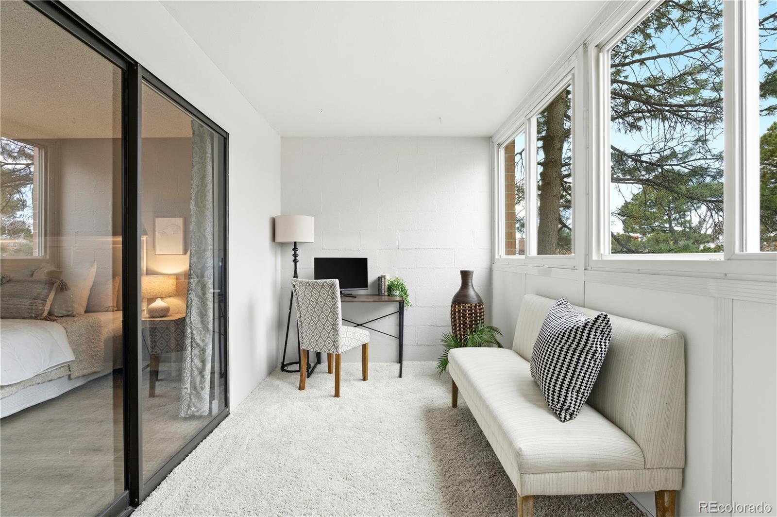 2880 South Locust Street, Unit 200S Denver, CO 80222 - Photo 22 of 43 a living room with furniture and a window