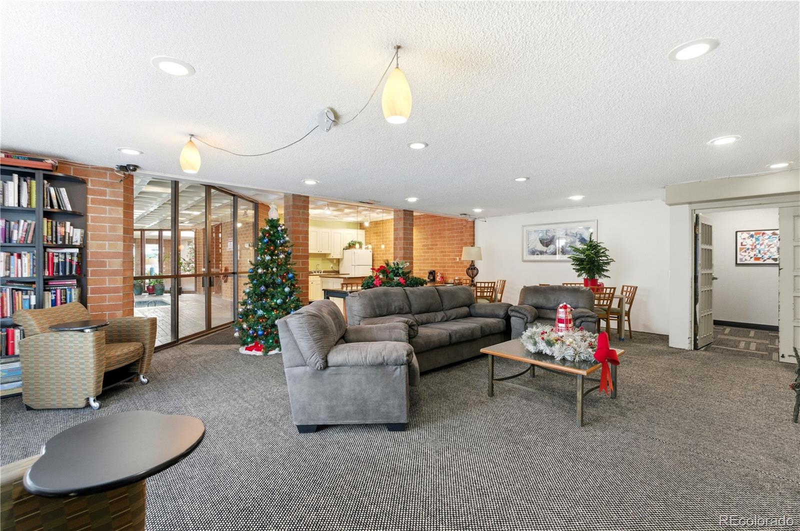 2880 South Locust Street, Unit 200S Denver, CO 80222 - Photo 31 of 43 a living room with furniture and a chandelier