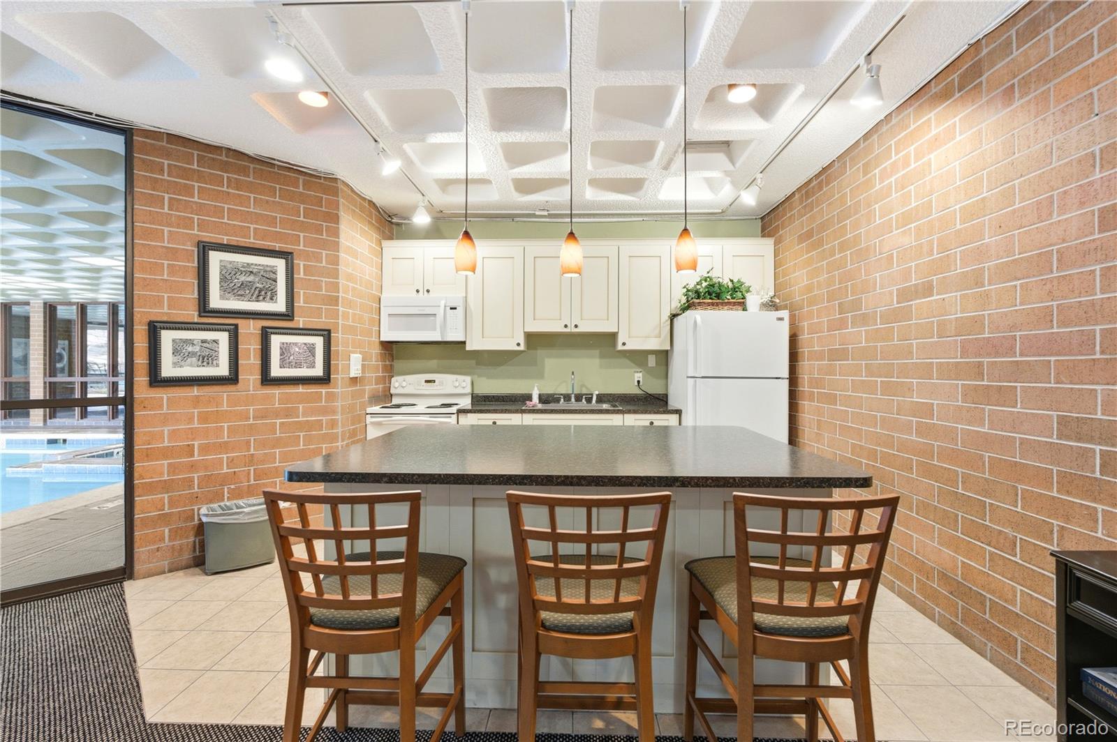 2880 South Locust Street, Unit 200S Denver, CO 80222 - Photo 32 of 43 a kitchen with stainless steel appliances granite countertop a sink and a refrigerator