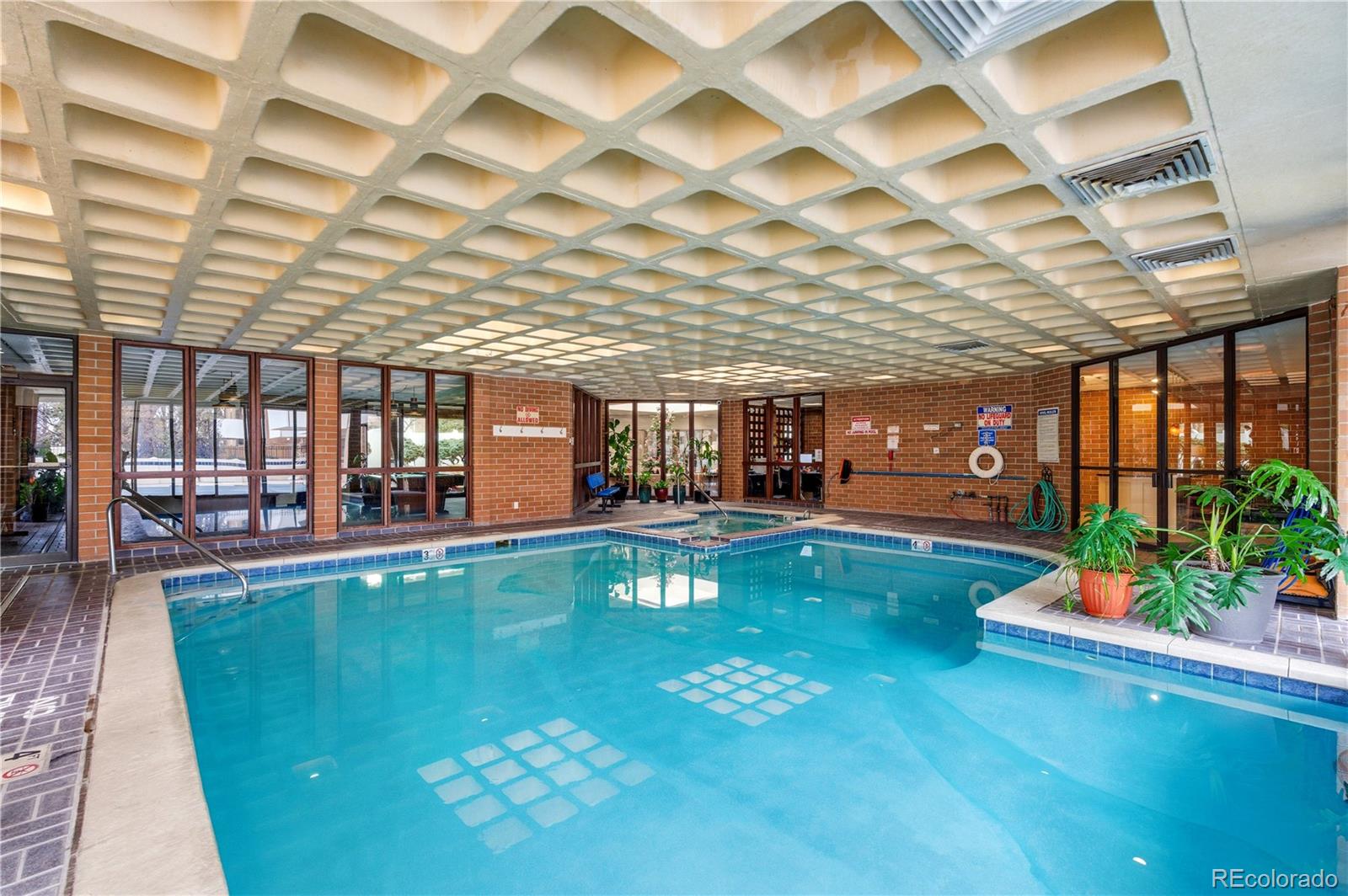 2880 South Locust Street, Unit 200S Denver, CO 80222 - Photo 36 of 43 a living room with lots of furniture wooden floor and a chandelier